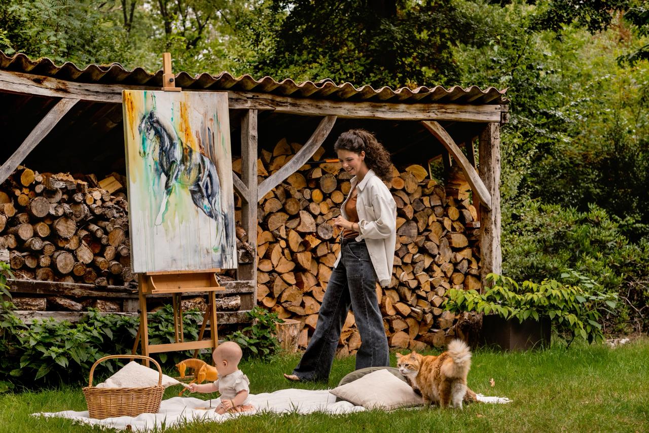 Marjo in her garden studio with her easel and family