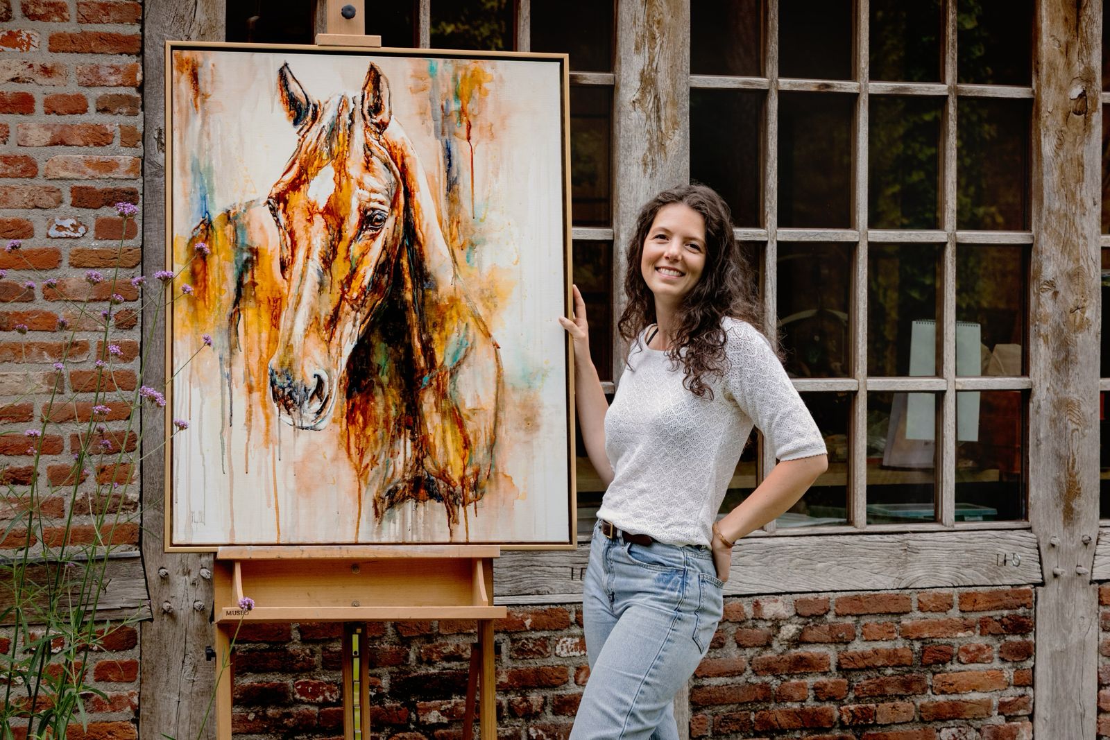 Marjo Lebbe beside her equine watercolour painting